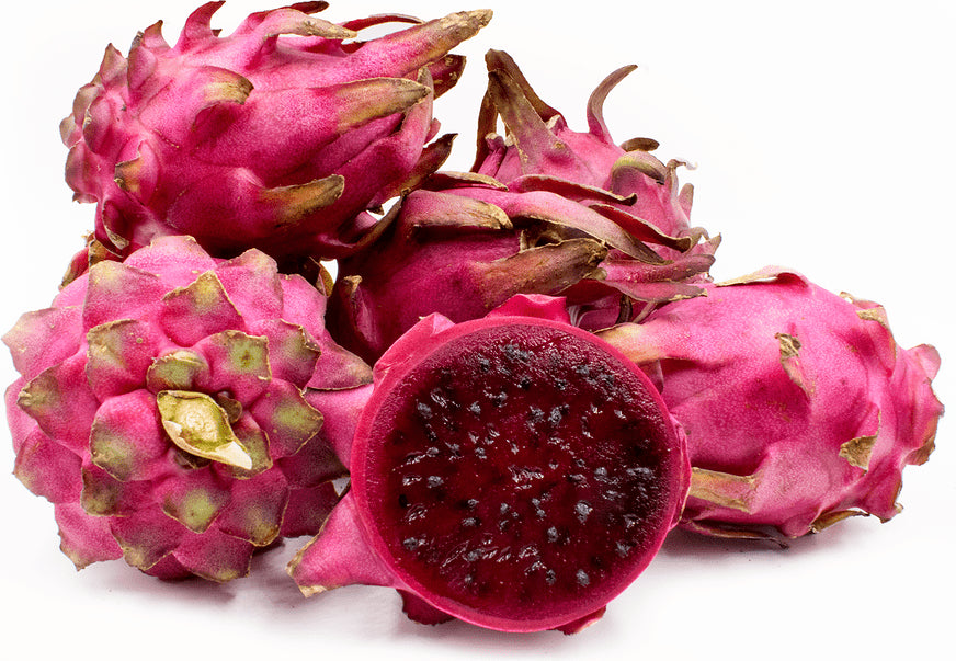 Pink skinned dragon fruit cut open to show the deep red flesh and black seeds of a red pitaya variety